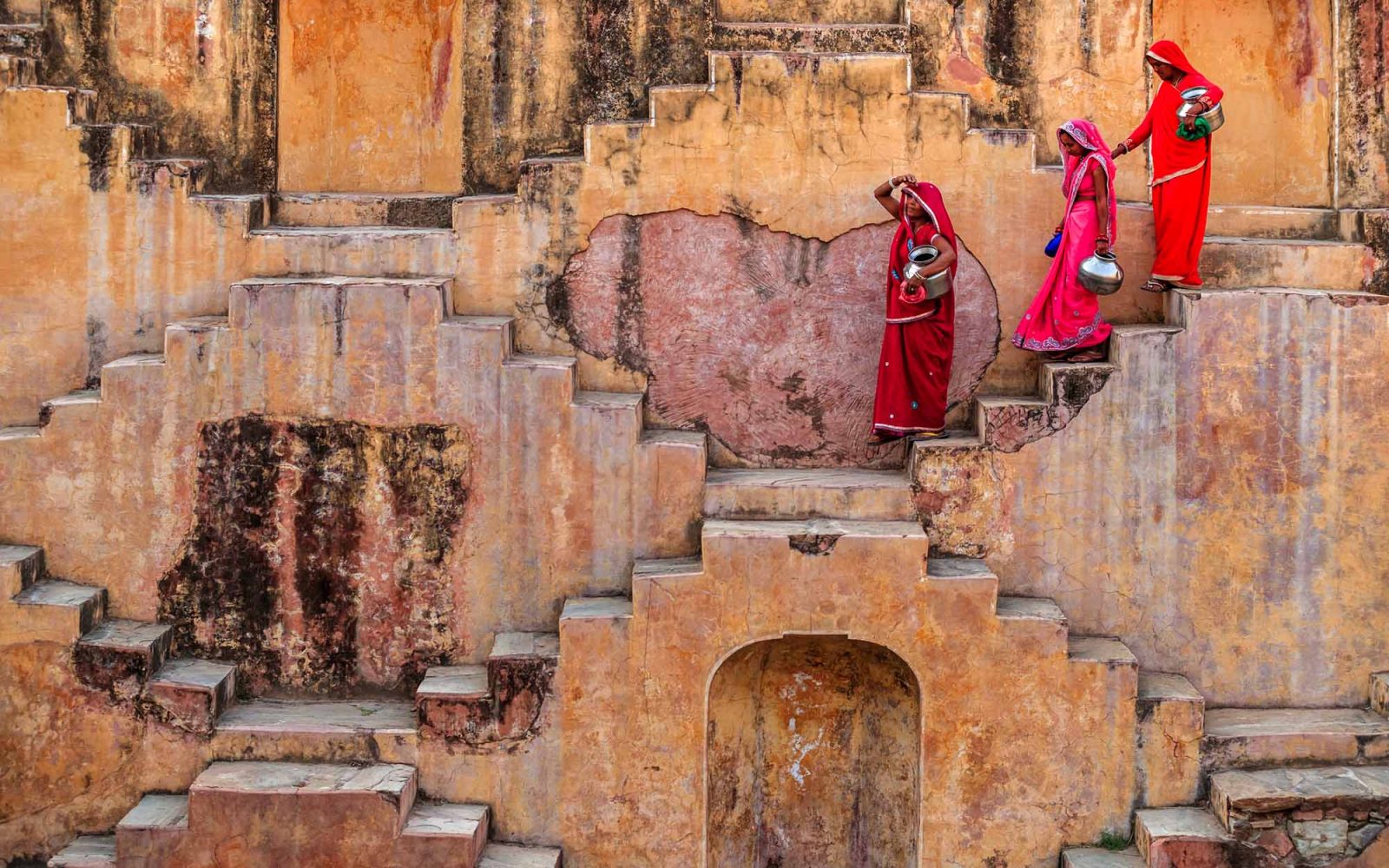 An image of Indian women carrying water from a stepwell near Jaipur.