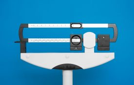 Medical weight scale on a blue background.