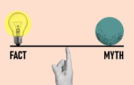 Finger holding a scale with Fact on the left and Myth on the right.